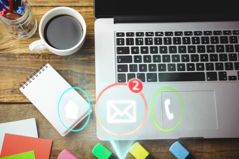 Overhead view of a laptop with email notification icons